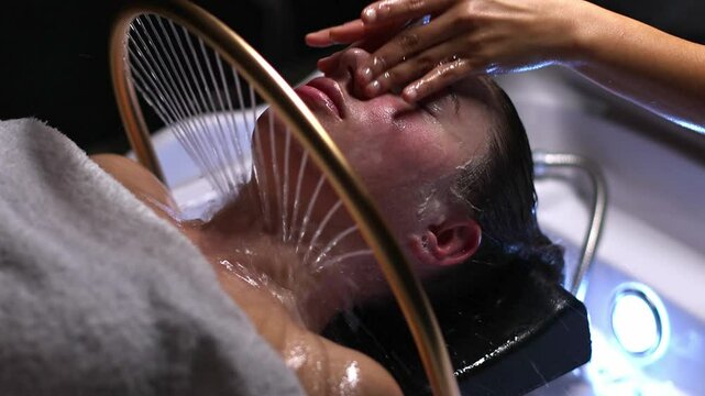 Spa treatment with Japanese head massage and hair washing in slow motion, young woman pampering, luxurious beauty treatment in a shampoo stand