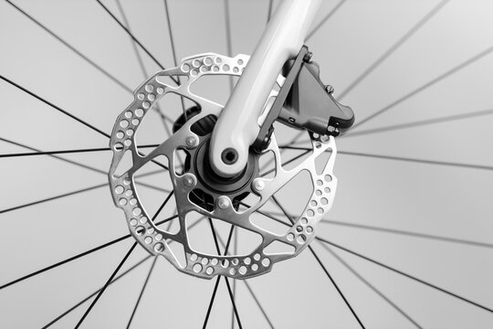 A close up of a bicycle's rear wheel with a silver chain and sprockets. Concept of motion and energy, as if the bicycle is in the process of being ridden - Powered by Adobe