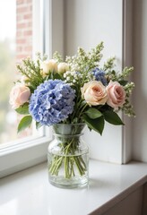Bouquet of blue hydrangea and pink roses in glass vase