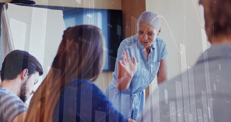 Image of financial data processing over diverse business people in office