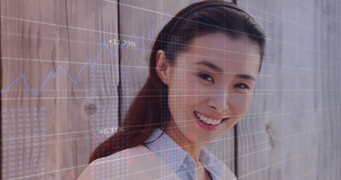 Image of financial data processing over asian businesswoman using tablet in office - Powered by Adobe