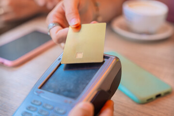Woman Making Contactless Payment with Credit Card in a Cafe