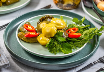Pickled pattypan squash and gherkins with fresh herbs and chili pepper