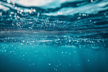 Underwater view of beautiful turquoise ocean water with bubbles rising to the surface, creating a serene and tranquil atmosphere