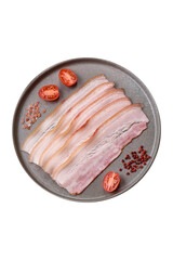 Fresh raw bacon sliced with spices and herbs