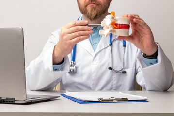 Anatomical lumbar disc herniation model in doctor hand while consultation in medical clinic. Intervertebral hernia treatment