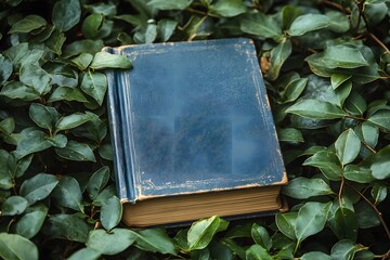Vintage Book Amidst Lush Greenery for Nature-Themed Design