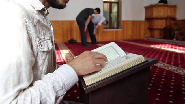 young muslim reading quran in mosque