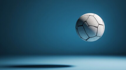 Naklejka premium Suspended Soccer Ball, Blue Studio Background, Minimalist Design