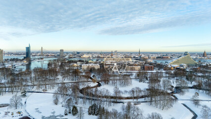 Obraz premium Winter Aerial View of Riga City Skyline, Ferris Wheel, Riga Castle, Old Town, Cathedral Towers, Academy of Sciences, National Library in the Background. Daugava River and City Bridges Riga, Latvia.