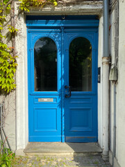 Blue double-leaf entrance door in the front entrance of Oldenburg. Elements of German architecture.