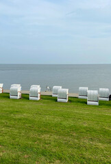 Beach on the North Sea. Striped wicker cabins on the beach. North Sea coast, Germany.