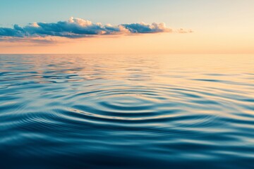 Tranquil Scene of Calm Ocean Waters Reflecting Golden Light and Soft Clouds at Sunset, Capturing a Serene Moment in Nature's Beauty