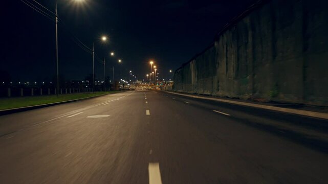Highway in outskirts, view from rear window of car or bus, riding on city roads. Travel by automobile road across country, street lamps illuminating way, developed transport infrastructure for traffic