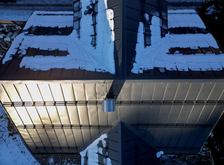 galvanized metal roof in mountains with a bar against rapid sliding of snow. If snow and ice...