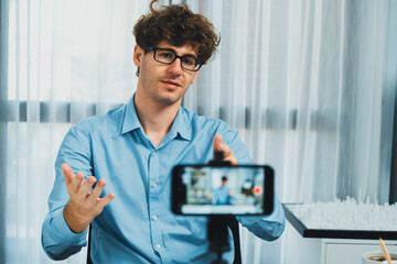 Host channel of architecture using smartphone teaching online broadcast structure building model design model, communicating with students or listeners on social media at modern home office. Gusher.