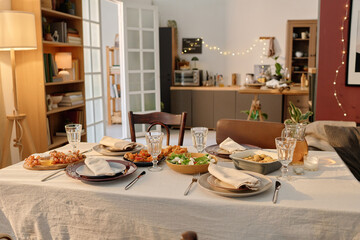 Wide shot of table covered with cotton tablecloth and served with delicious homemade food