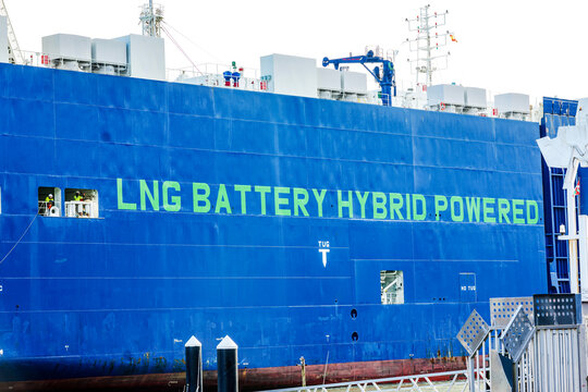 Pasajes, Spain - January 15 2025. A large hybrid-powered cargo ship docked in a harbor.