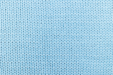 Texture of blue knitted fabric with rows of loops
