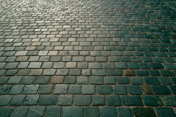 Pavement road. Stone cladding. Rough brick road. Cobblestone pavement background. Textured background. Sidewalk. Road. Old cobblestone road.