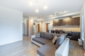 Modern Home Open Plan Kitchen and Living Room Interior with Dining Table and Window View. A...