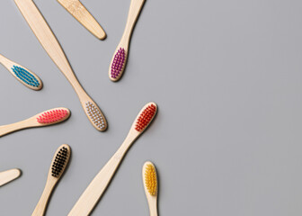 Colorful biodegradable bamboo toothbrushes on a gray top view. Zero waste and no plastic concept