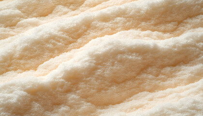 Close-up texture of fine, light beige powder; soft, fluffy, and smooth surface. Ideal for backgrounds or product displays.