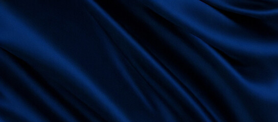 Fototapeta premium Deep navy blue silk fabric with flowing folds for luxury branding and elegant designs. Banner, header
