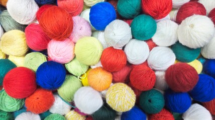 Colorful yarn balls forming a textured background for creative projects