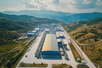 Fototapeta premium Lithium processing plant stands in a valley surrounded by hills, promoting sustainable energy production