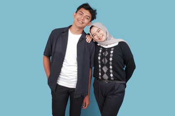 young asian couple isolated on blue backround