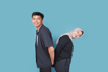 Portrait of Happy asian College man an women with jiba isolated on blue backround. Portrait of happy Asian muslim couple smiling, husband and wife hugging full of love, family concept