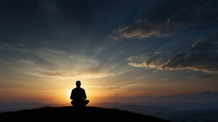 Silhouette of a devout man pray to the Allah on hill