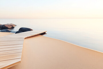 Serene wooden walkway leading to calm water at sunrise by the beach