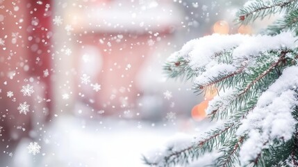 Naklejka premium A winter background image showing snow falling on pine tree branches with blurred lights in the background