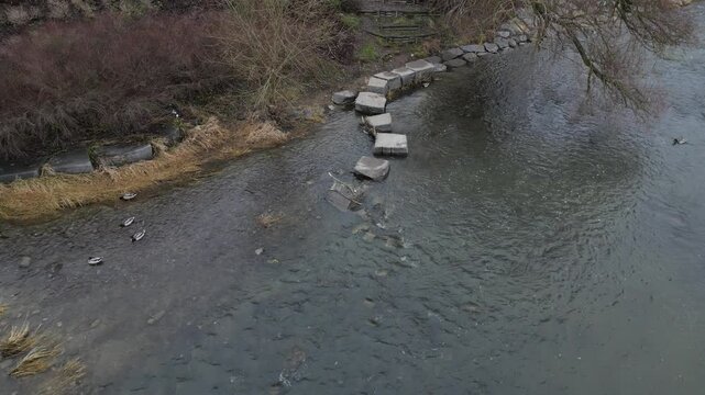 newly created natural embankment by river. benches, terraces, relaxed staircase serve people as well as fishing and relaxation. strengthening banks against water erosion by large stones on dry lined 