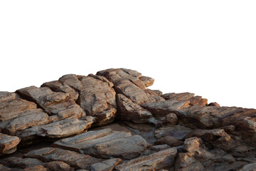 a sunlit rock cliff isolated against a white background. The sun casts warm tones and shadows across the rocky surface