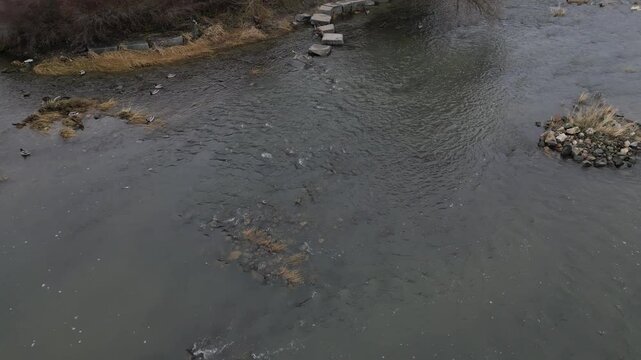 newly created natural embankment by river. benches, terraces, relaxed staircase serve people as well as fishing and relaxation. strengthening banks against water erosion by large stones on dry lined 