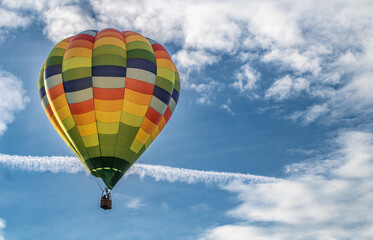 Brightly colored hot air balloons against blue skies 