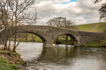 Stone bridge over the river Lune in Cumbria on an overcast day in early spring.