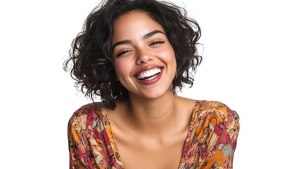 A joyful woman with curly hair and a vibrant top smiles brightly, radiating happiness and confidence in a captivating portrait setting.