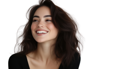 A joyful young woman with dark, wavy hair smiles radiantly, capturing a moment of genuine happiness and positivity.