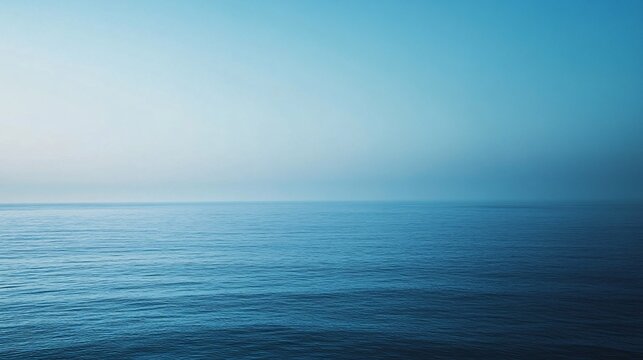 Tranquil Ocean Horizon Under a Clear Blue Sky at Dawn