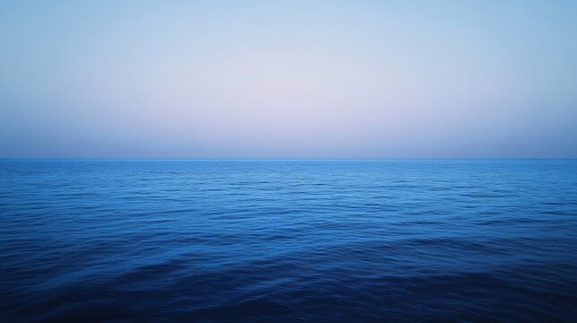 Tranquil Ocean Horizon Under a Clear Blue Sky at Dawn