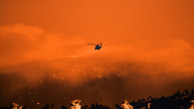 Firefighting helicopter battles flames in Los Angeles during wildfires of 2025