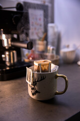 Hot coffee in a drip bag in a cup
