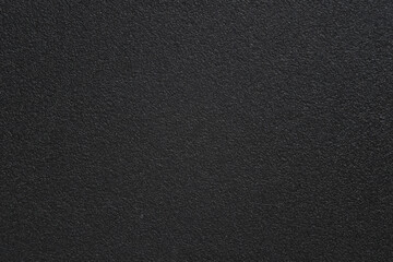 Full frame of plastic surface. Dark abstract textured background. Artifical plastic surface with...