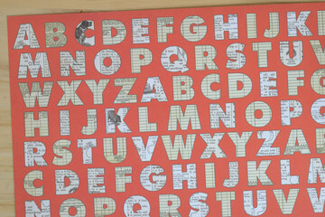 decorative scrapbooking paper with alphabet on wood