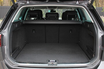 Huge empty trunk of a wagon car.  Open back door modern car. Car boot is open. Wagon clean trunk. Modern wagon car open trunk. Front view.