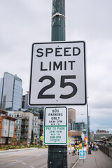 Traditional American speed limit, bus parking only and pay for parking sign in downtown, Seattle, USA.